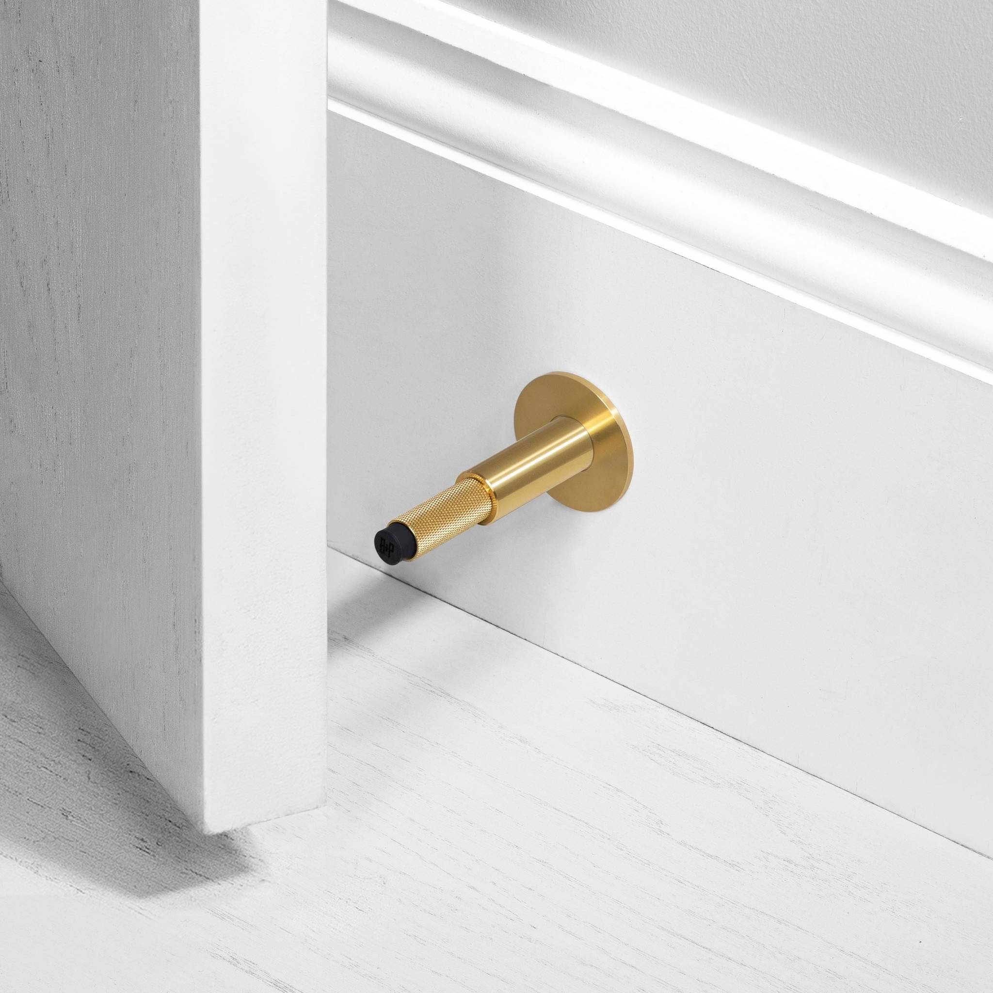 Buster + Punch Door Stop Wall Cross in Brass