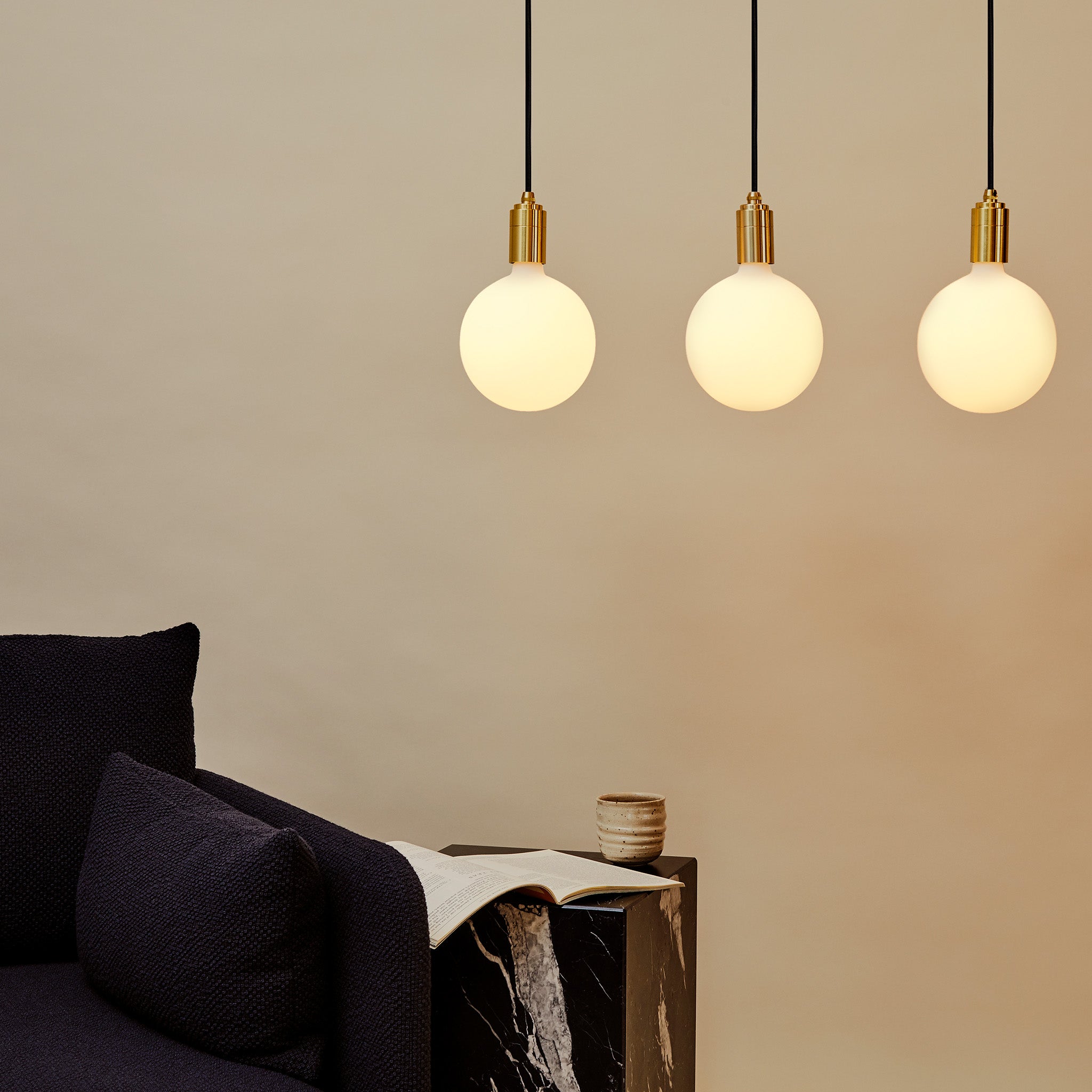 Tala Linear Triple Pendant in Brass in a styled interior setting (view 2)